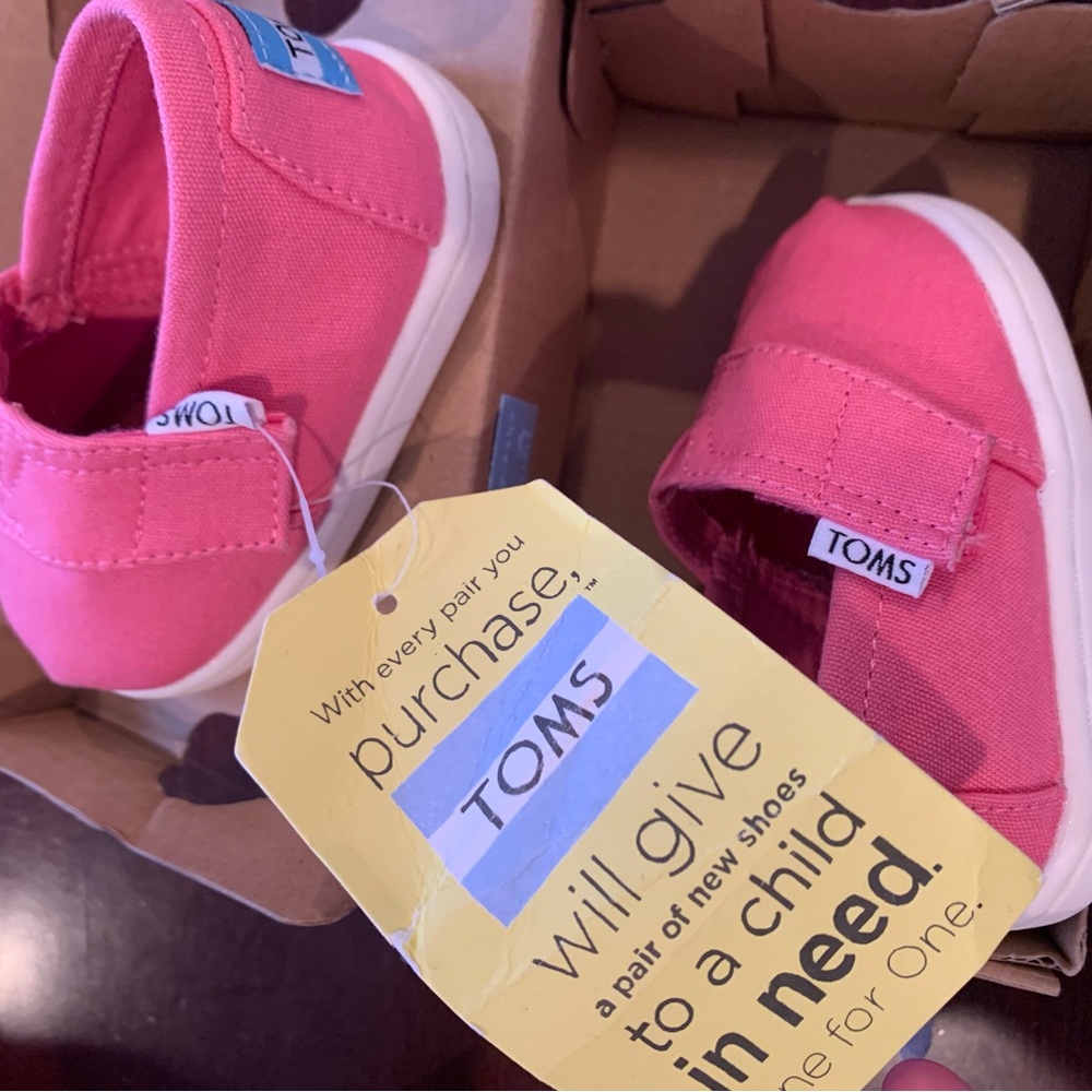 Bubblegum pink canvas TOMS shoes.